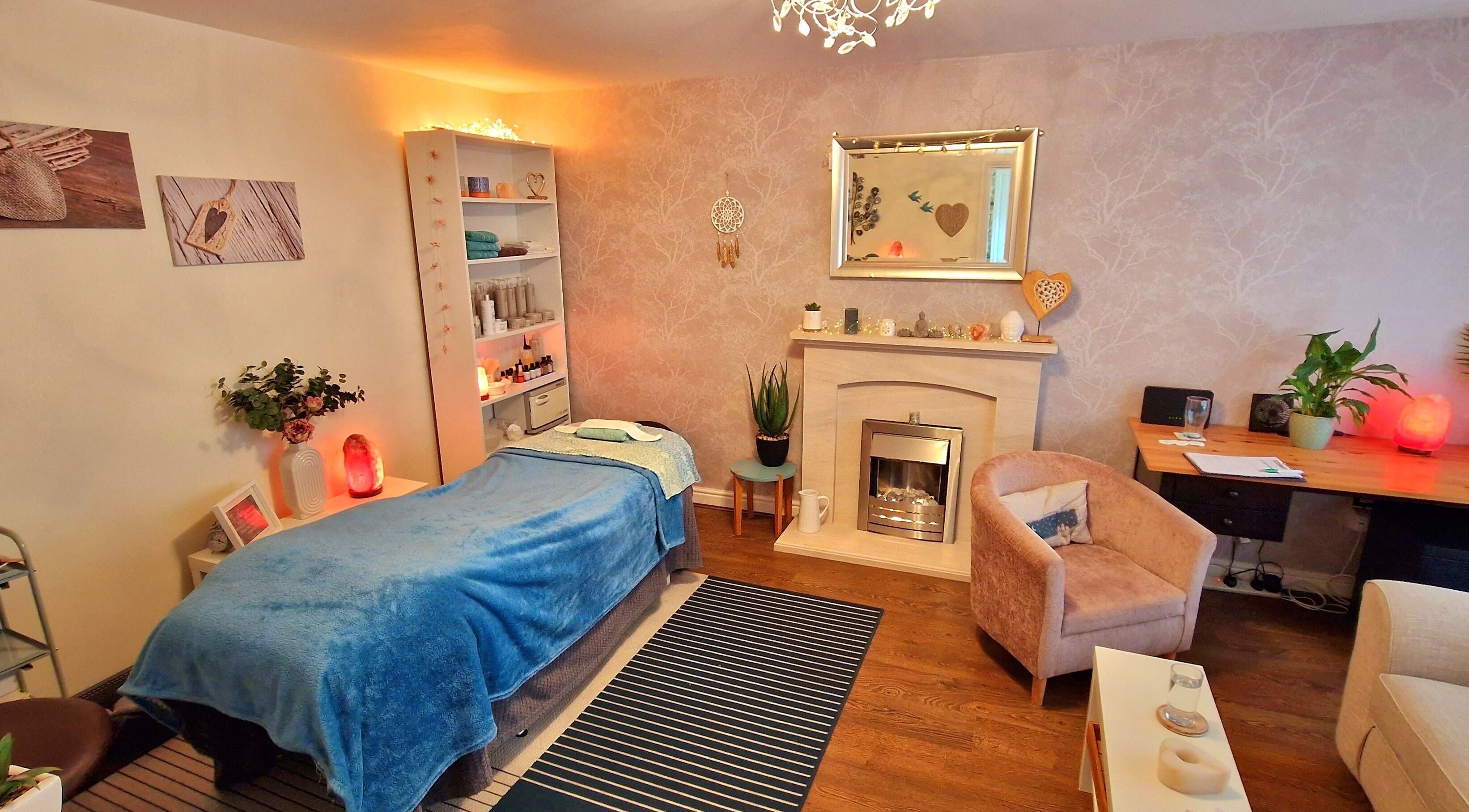 Cozy therapy room at Springhill Therapy, Buckshaw Village, England, GB, featuring a massage bed and calming decor.