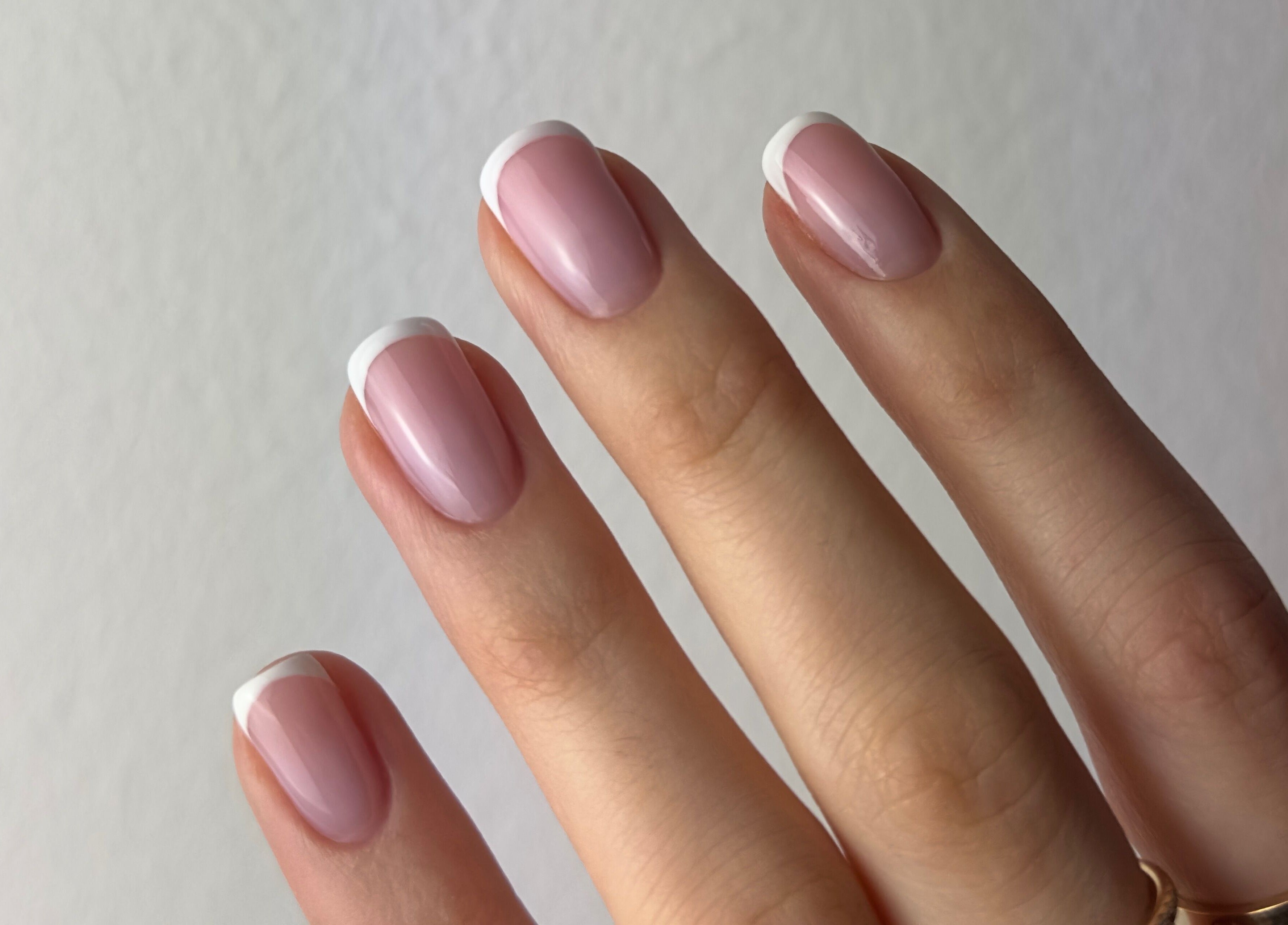 Chic French manicure on hand at Koliya Nails, Wien, Wien, AT. Perfectly shaped and polished nails.