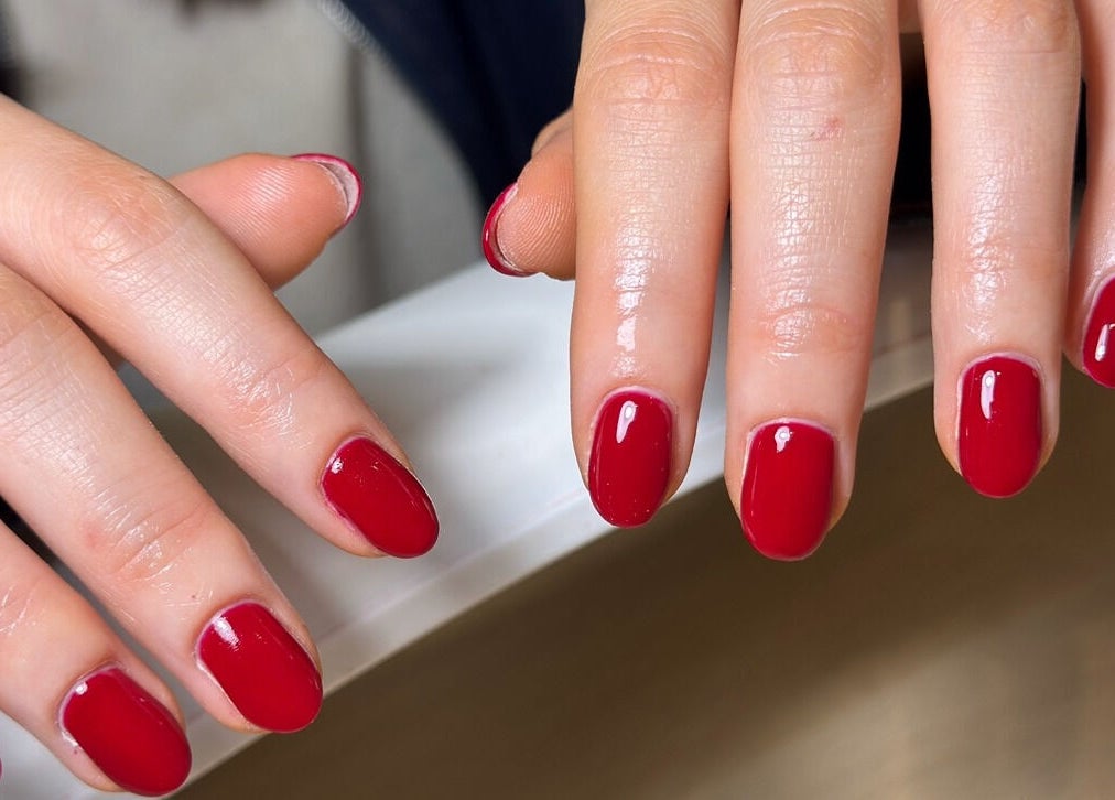 Elegant red nail manicure at LCBeauty, Swindon, England, GB, showcasing pristine nail art.