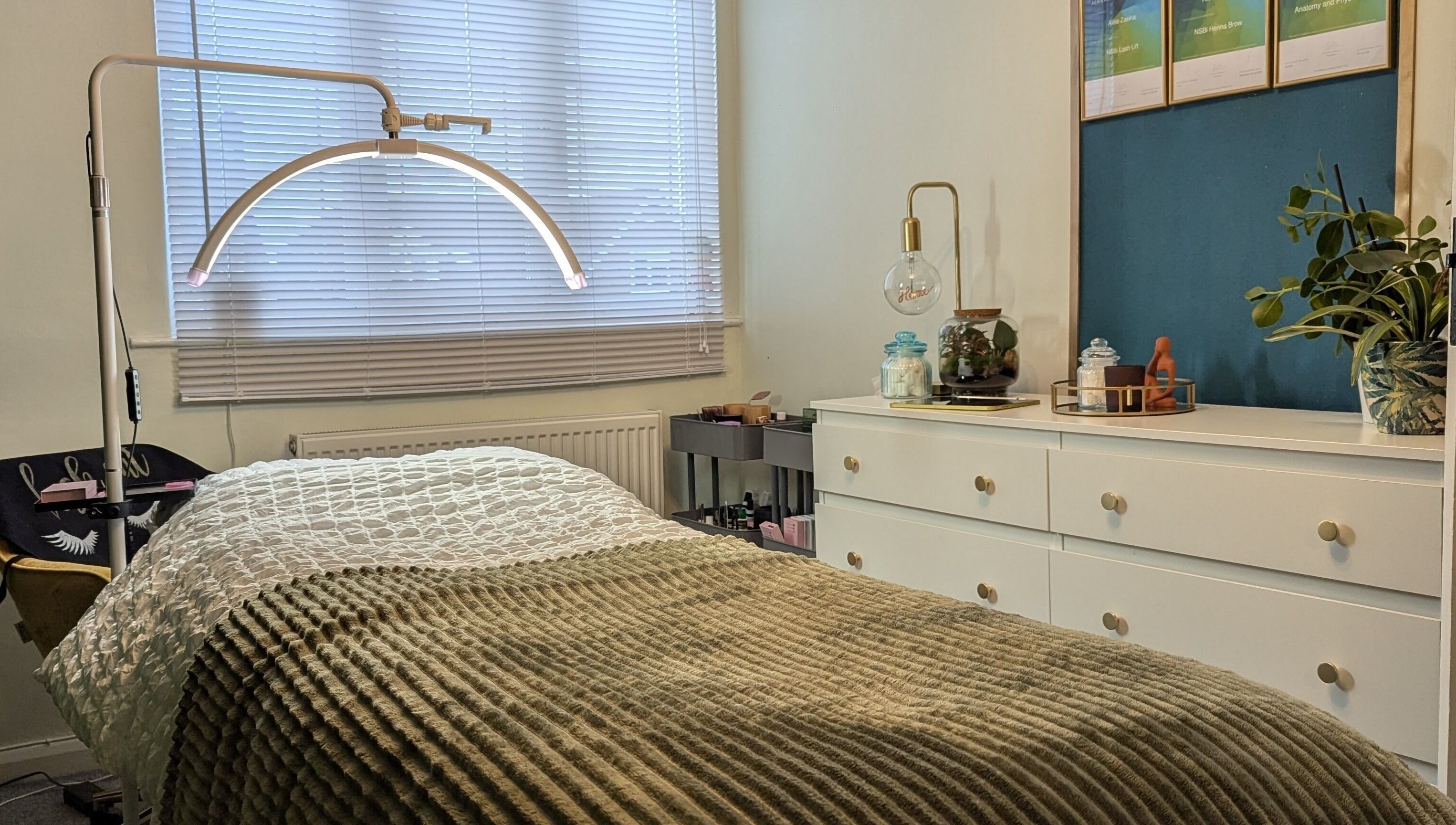 Cozy treatment room at Affinity Beauty Windsor, England, GB with plush bedding and calming decor.