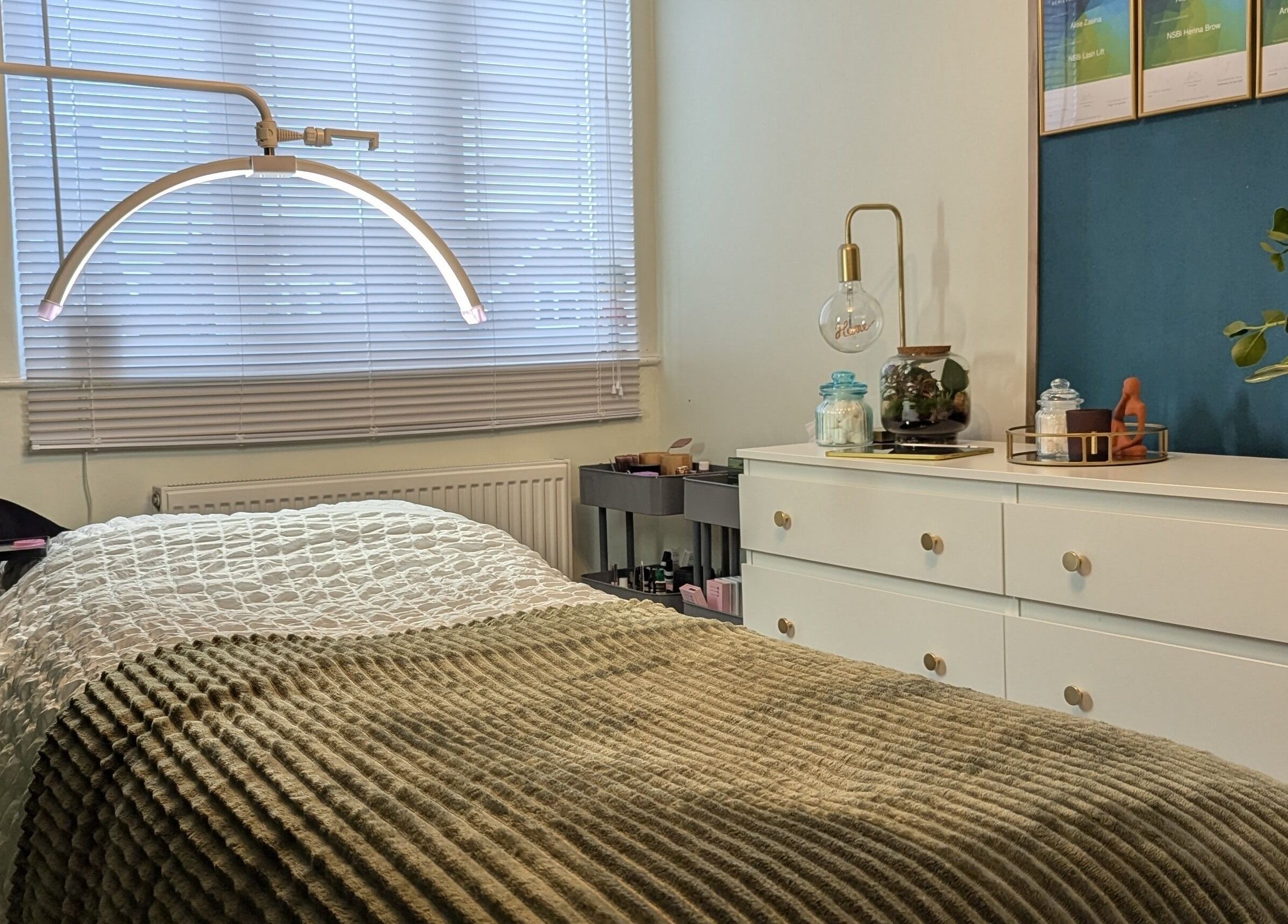 Cozy treatment room at Affinity Beauty Windsor, England, GB with plush bedding and calming decor.