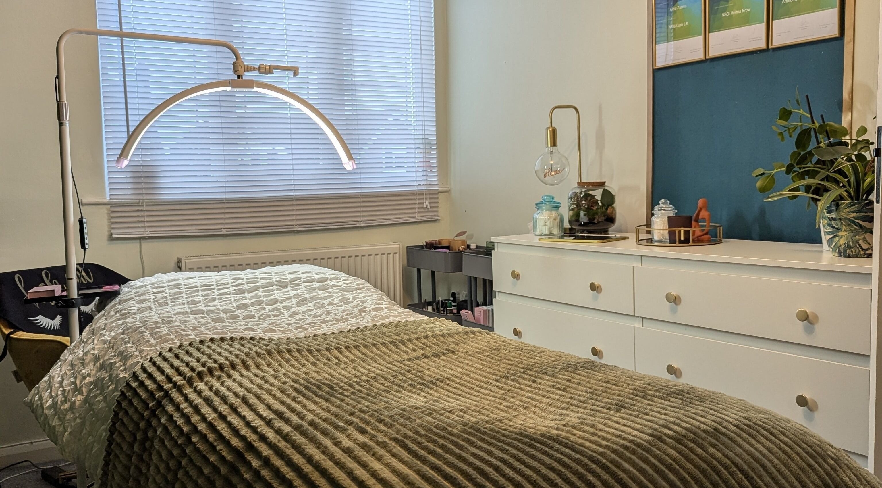 Cozy treatment room at Affinity Beauty Windsor, England, GB with plush bedding and calming decor.