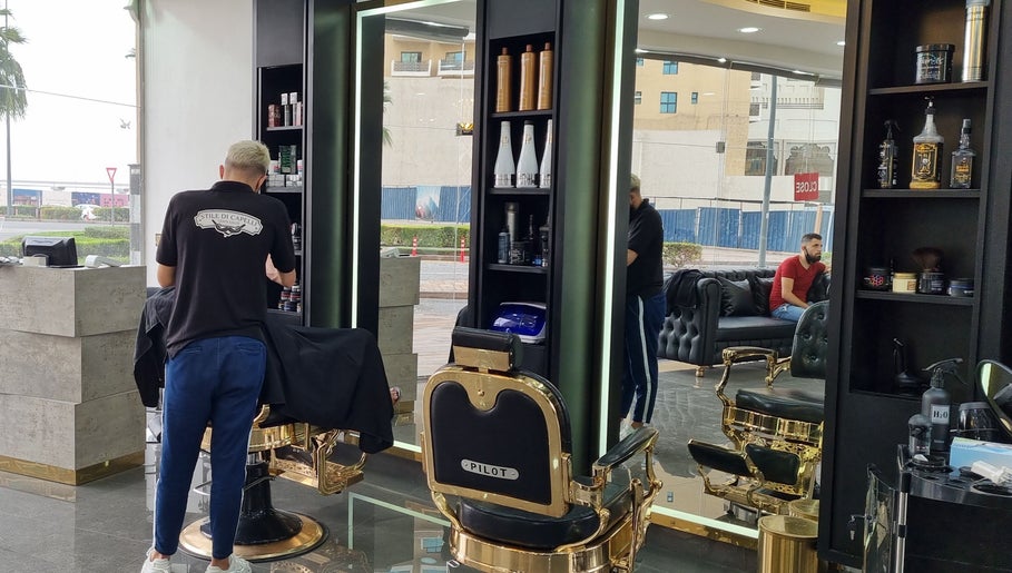 Stylish interior of Stile Di Capelli Gents Salon in Dubai, Dubai, AE showcasing barber chairs and products.