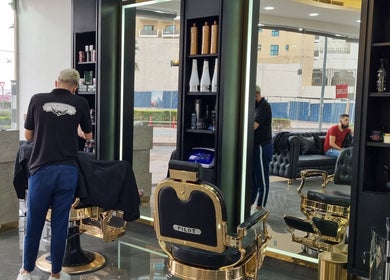 Stylish interior of Stile Di Capelli Gents Salon in Dubai, Dubai, AE showcasing barber chairs and products.