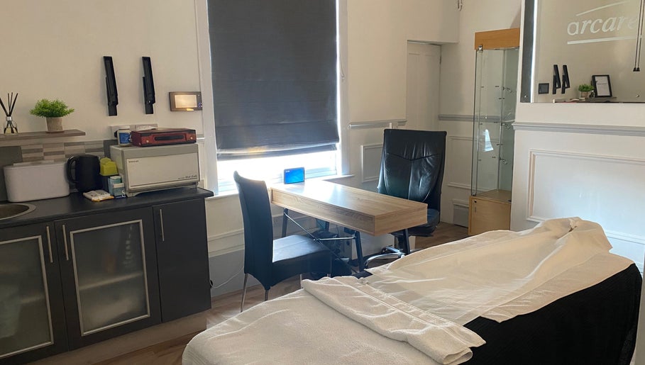 Bright therapy room at Kitson Care in Wolverhampton, England, GB with a cozy massage table and modern decor.