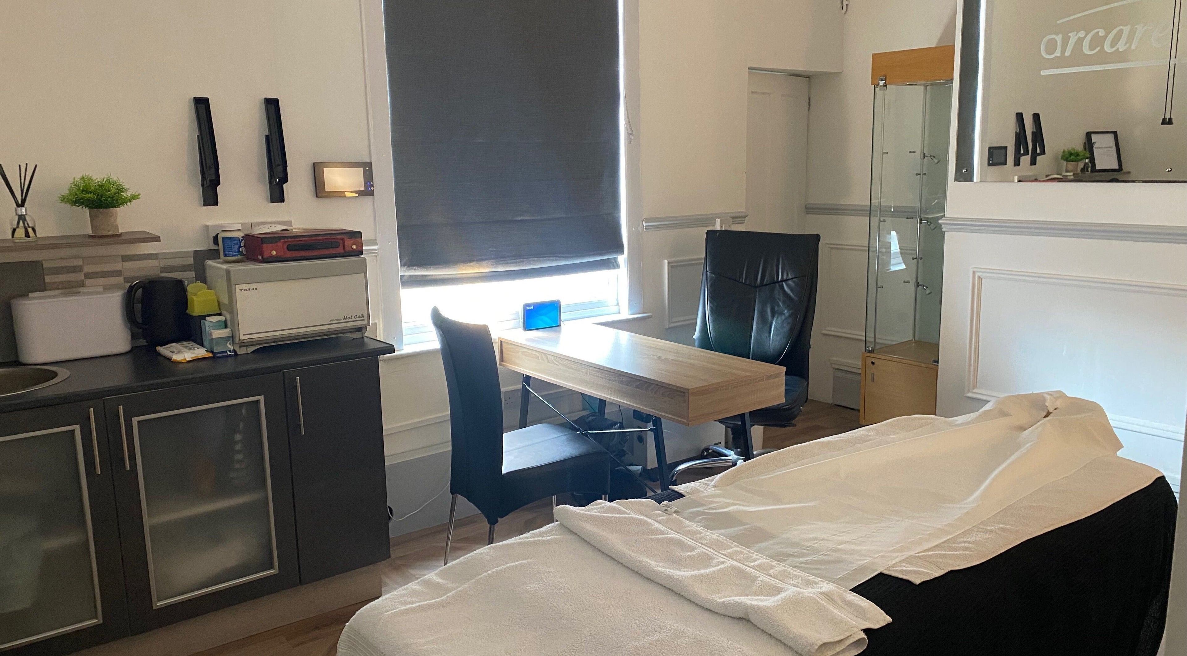 Bright therapy room at Kitson Care in Wolverhampton, England, GB with a cozy massage table and modern decor.