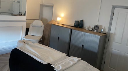 Cozy spa room at Kitson Care, Wolverhampton, England, GB with a white chair and soothing decor.