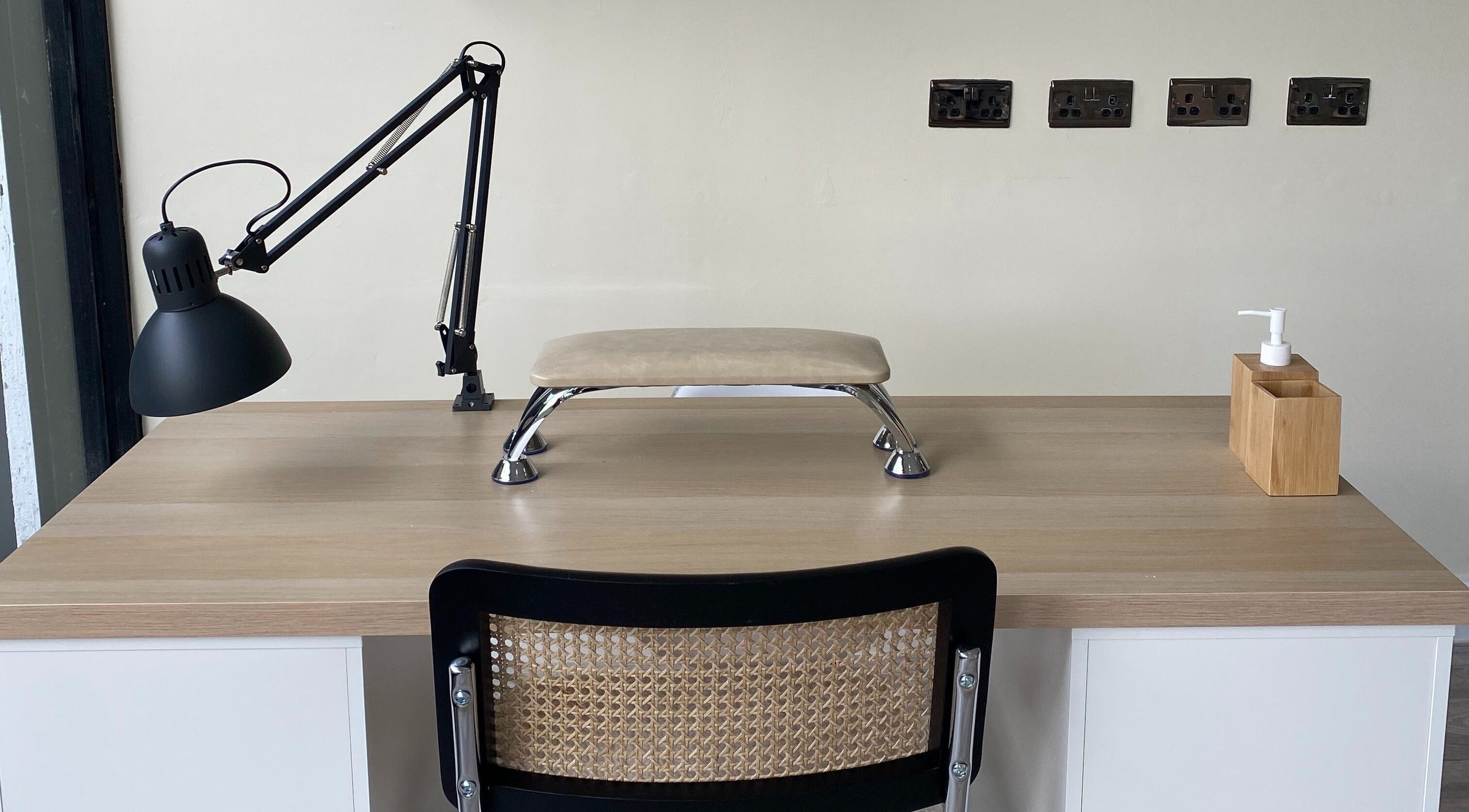Modern nail care setup at Oh So Pretty, Wigston, England, GB with lamp, hand rest, and sanitizer.
