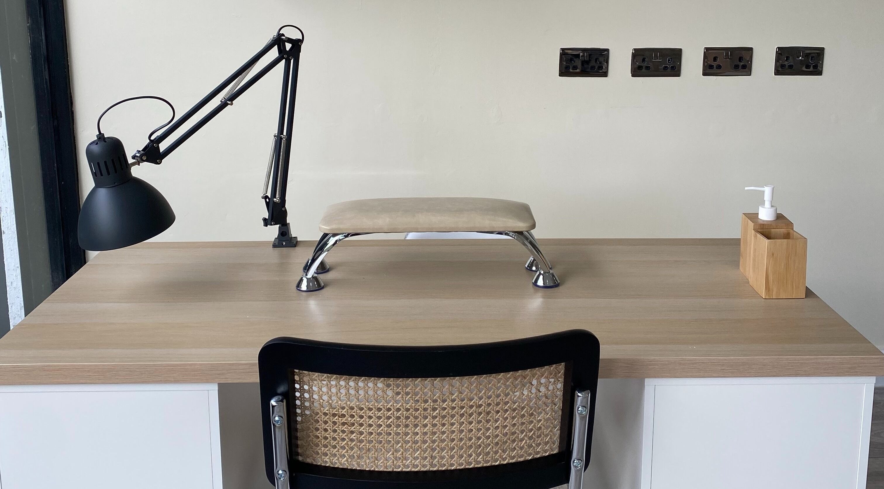 Modern nail care setup at Oh So Pretty, Wigston, England, GB with lamp, hand rest, and sanitizer.