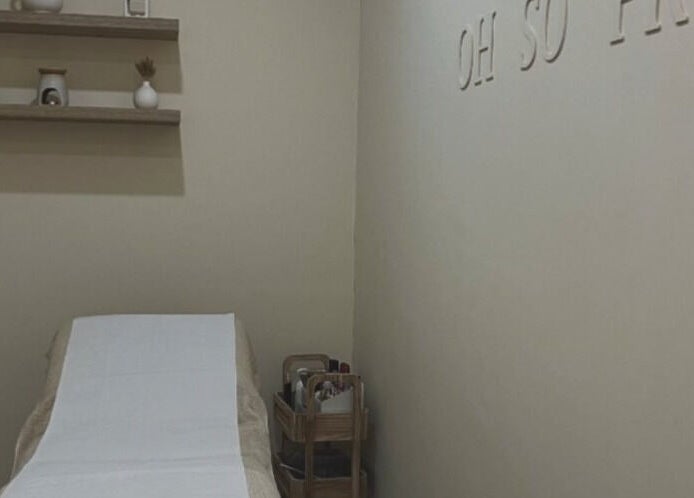 Oh So Pretty treatment room in Wigston, England. Cozy ambiance with treatment bed and minimalist decor.