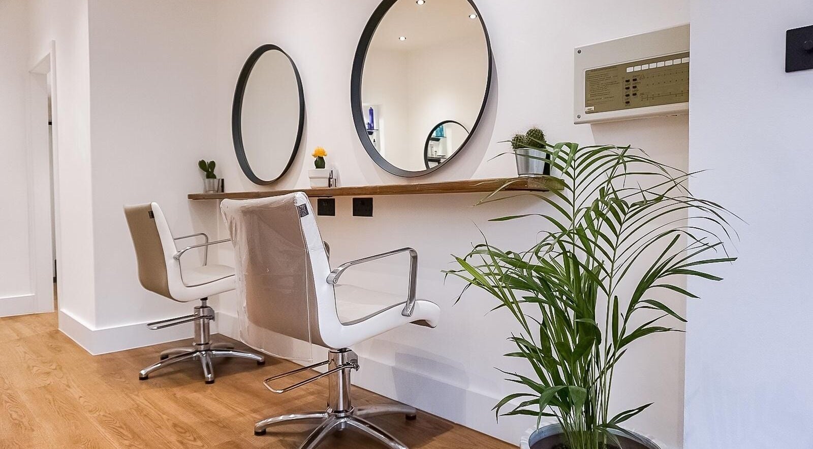 Stylish salon chairs and mirrors at Create Salon in Cardiff, Wales, GB, highlighting modern design.