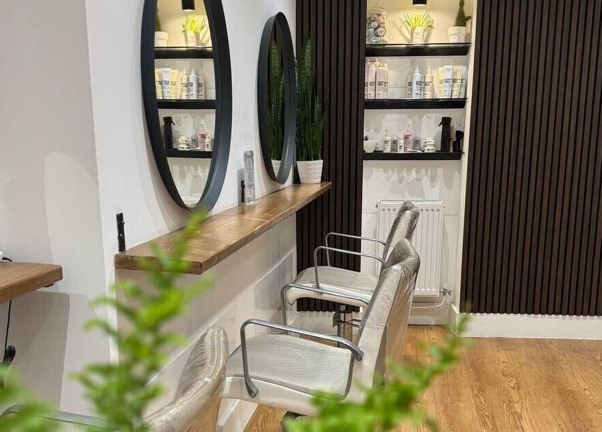 Create Salon in Cardiff, Wales, GB features sleek design with round mirrors and stylish chairs.