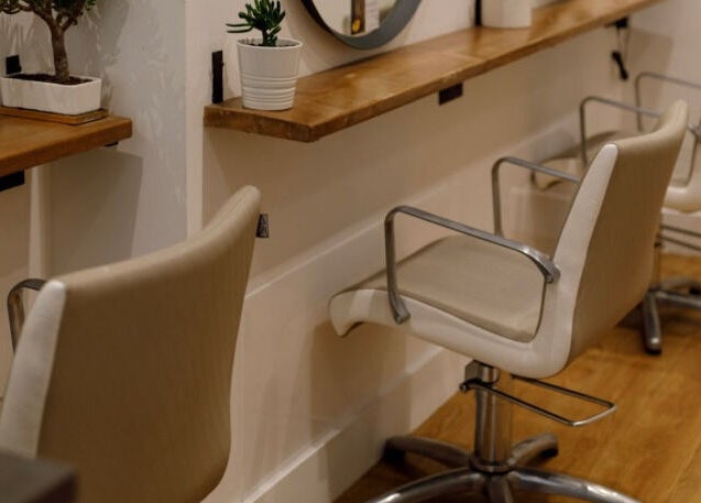 Modern hair styling chairs in Create Salon, Cardiff, Wales, GB, offering inviting and elegant beauty services.