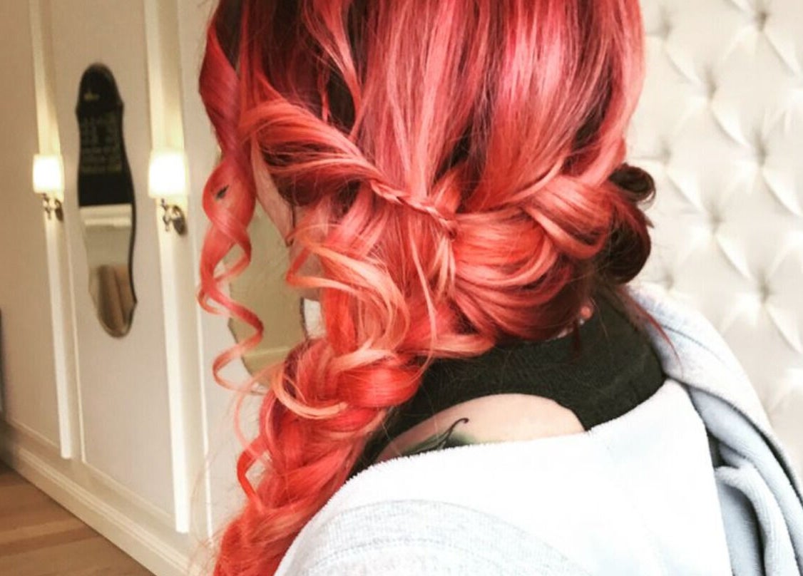 Intricate red hair braid styled at Villain Salon Studio, Denver, Colorado, US for vibrant look.