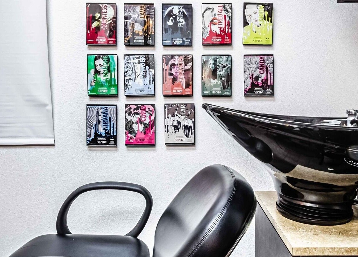 Modern salon chair and wash basin at Villain Salon Studio, Denver, Colorado, US. Stylish wall art displayed.
