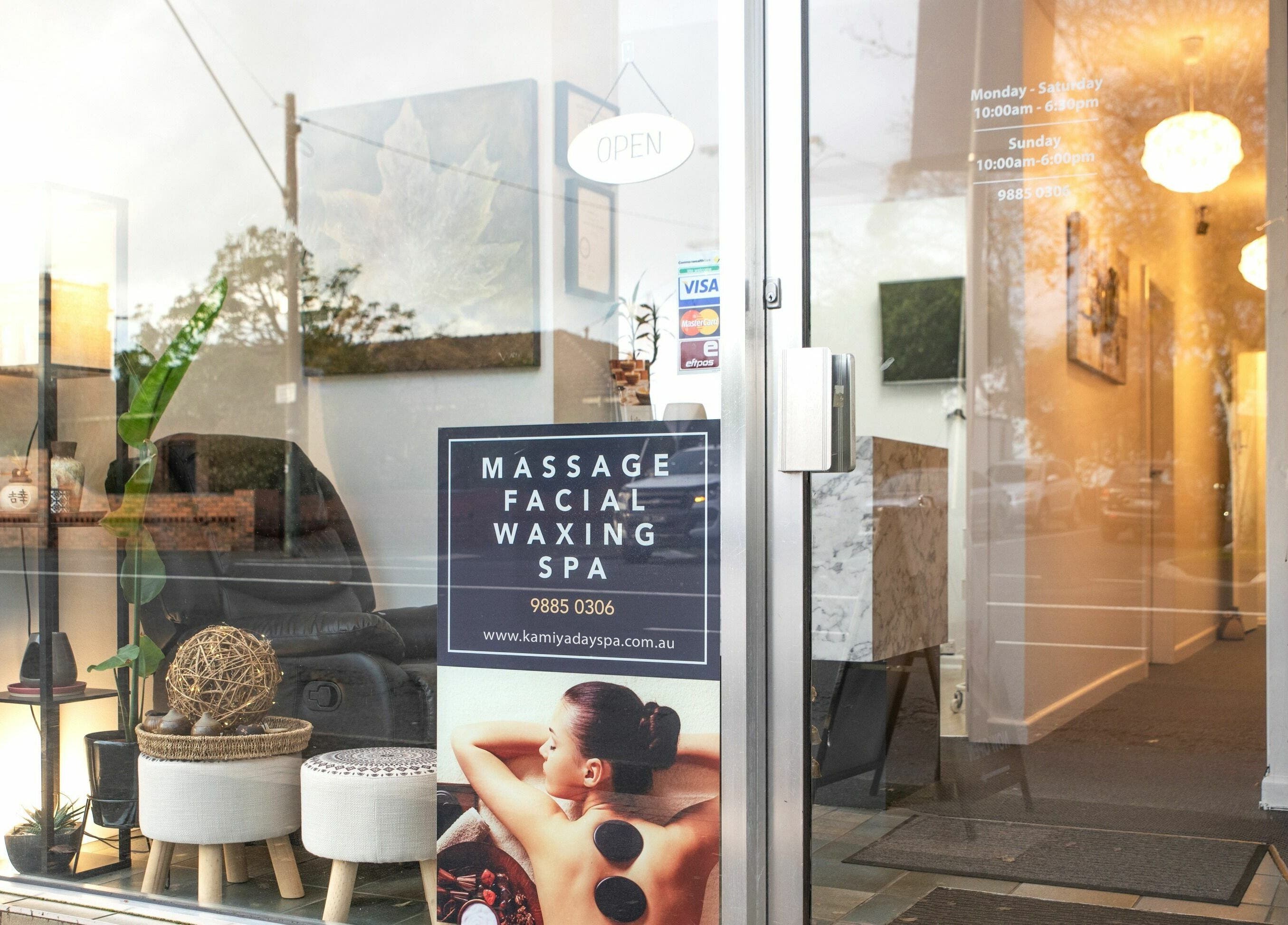 Entrance of Kamiya Day Spa in Ashburton, Victoria, AU, featuring a glass door and spa service signage.