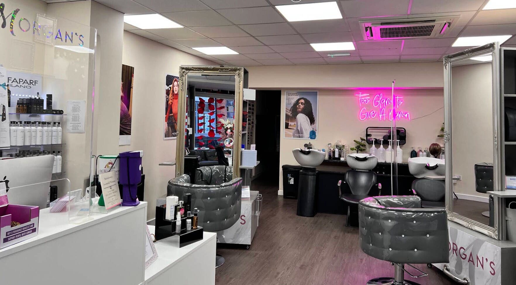 Stylish interior of Morgan's Wigs and Hairdressing Prestatyn in Denbighshire, Wales, GB showcasing modern hairdressing chairs.