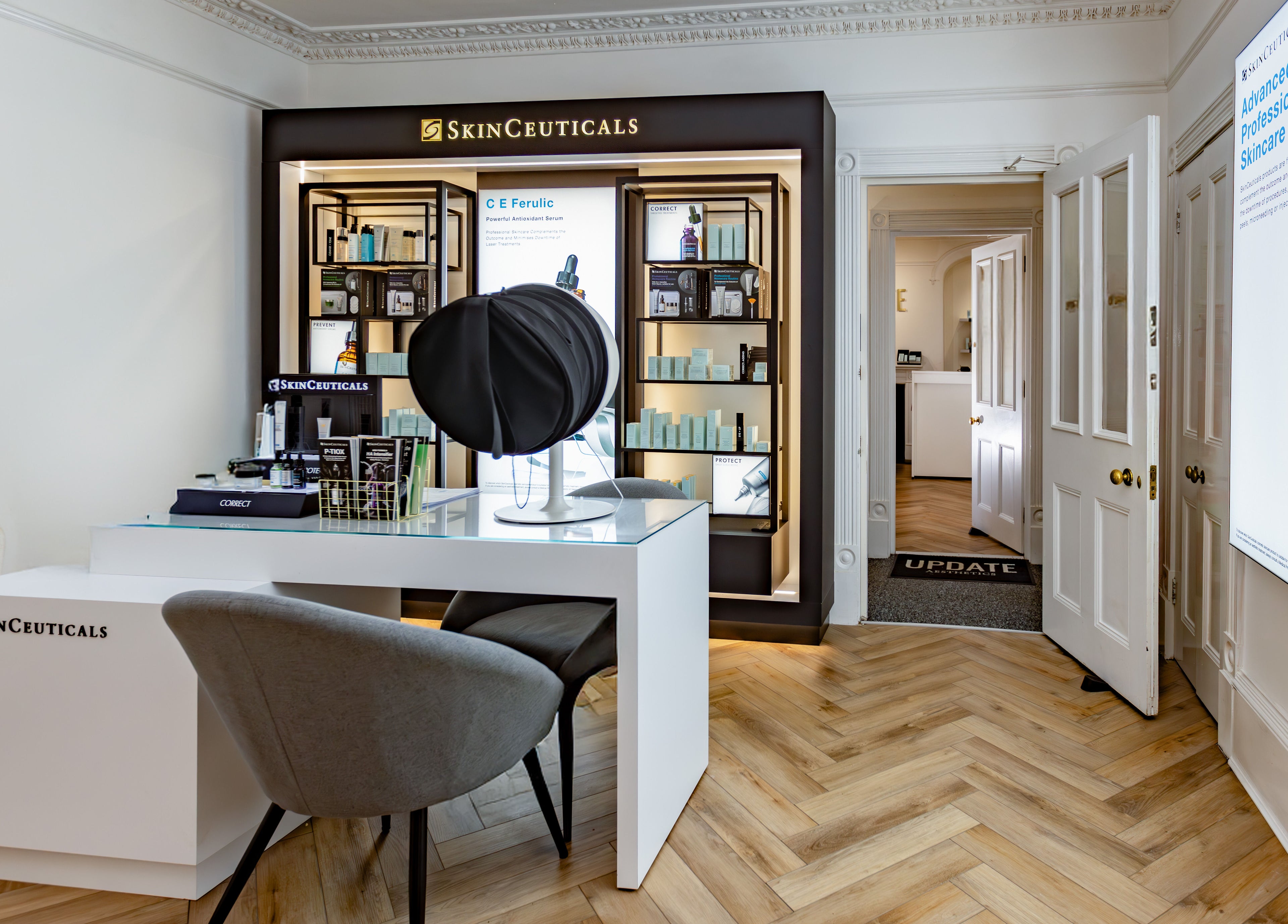 Modern interior of Update Aesthetics Lemon Street, Truro, England, GB, showcasing skincare products.