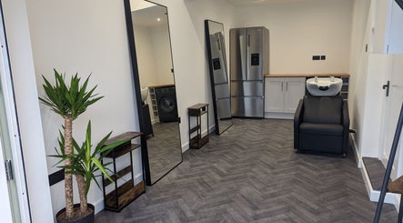 Modern salon area at The Salon, Bollington, United Kingdom, GB featuring sleek mirrors and washing station.
