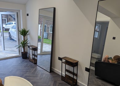 Bright salon interior with mirrors and plants at The Salon, Bollington, United Kingdom, GB.