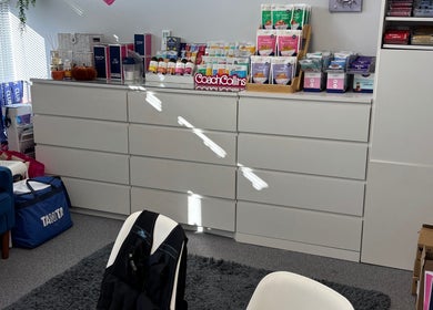 Bright wellness room at Coach Collins - The 1:1 Diet, Southampton, showcasing wellness products and seating area.