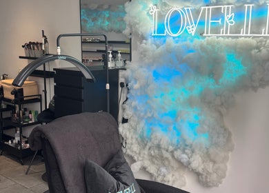 Chic interior of Lovelli Lashes Brows and Training in Halfway, England, GB featuring neon sign and beauty setup.