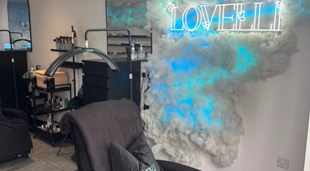 Cozy corner at Lovelli Salon & Training Academy, Halfway, England, GB with neon sign and beauty setup.