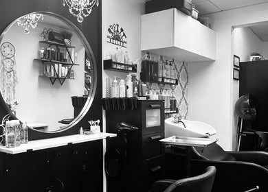 Chic and modern interior of Shagan Hair salon in Mesa, Arizona, US, featuring mirror and styling chairs.