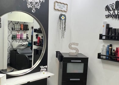 Elegant interior of Shagan Hair salon in Mesa, Arizona, US showcasing styling products and a chic mirror.