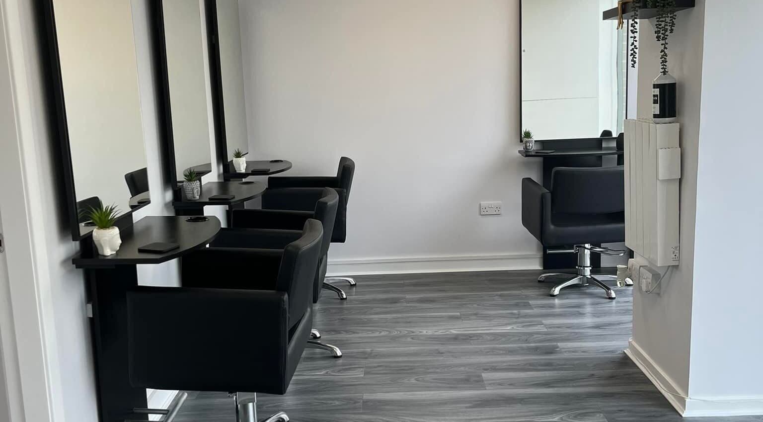 Stylish salon setup at Ashleah Marie Hairdressing, Stirling, Scotland, GB, featuring modern black chairs and mirrors.