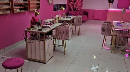 Elegant pink interior of Kenzo Nail Bar, Benoni, Gauteng, ZA with stylish nail stations and plush seating.