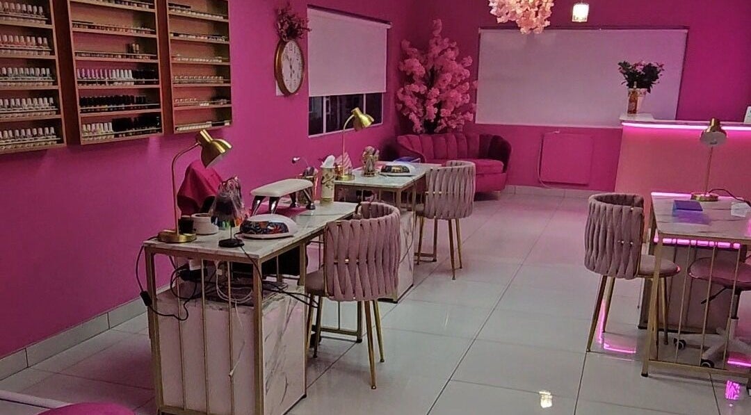 Chic interior of Kenzo Nail Bar in Benoni, Gauteng, ZA with elegant pink decor and manicure stations.