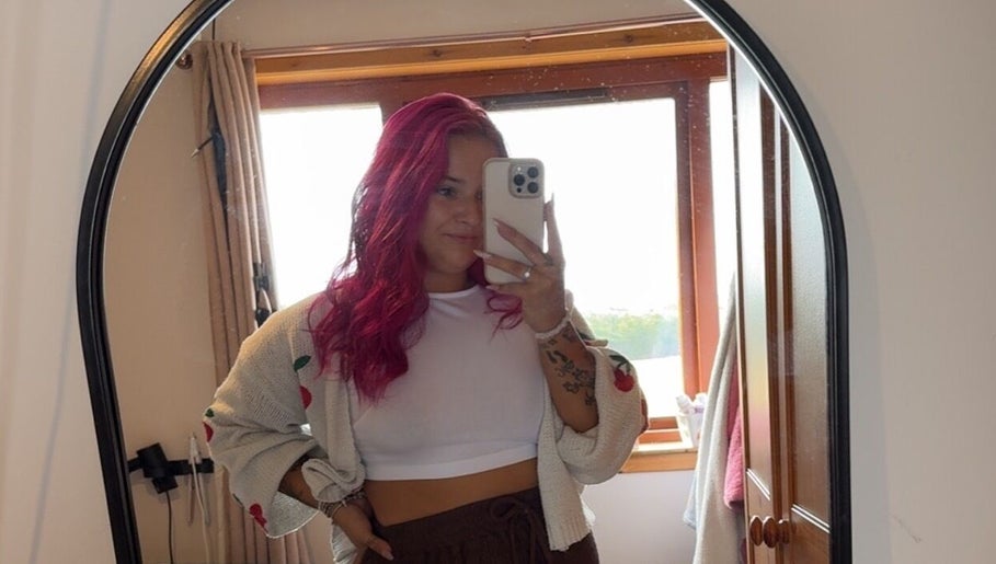 Person with vibrant red hair taking a mirror selfie at Agi’s Nails, Thurso, Scotland, GB.