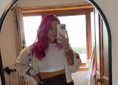 Person with vibrant red hair taking a mirror selfie at Agi’s Nails, Thurso, Scotland, GB.