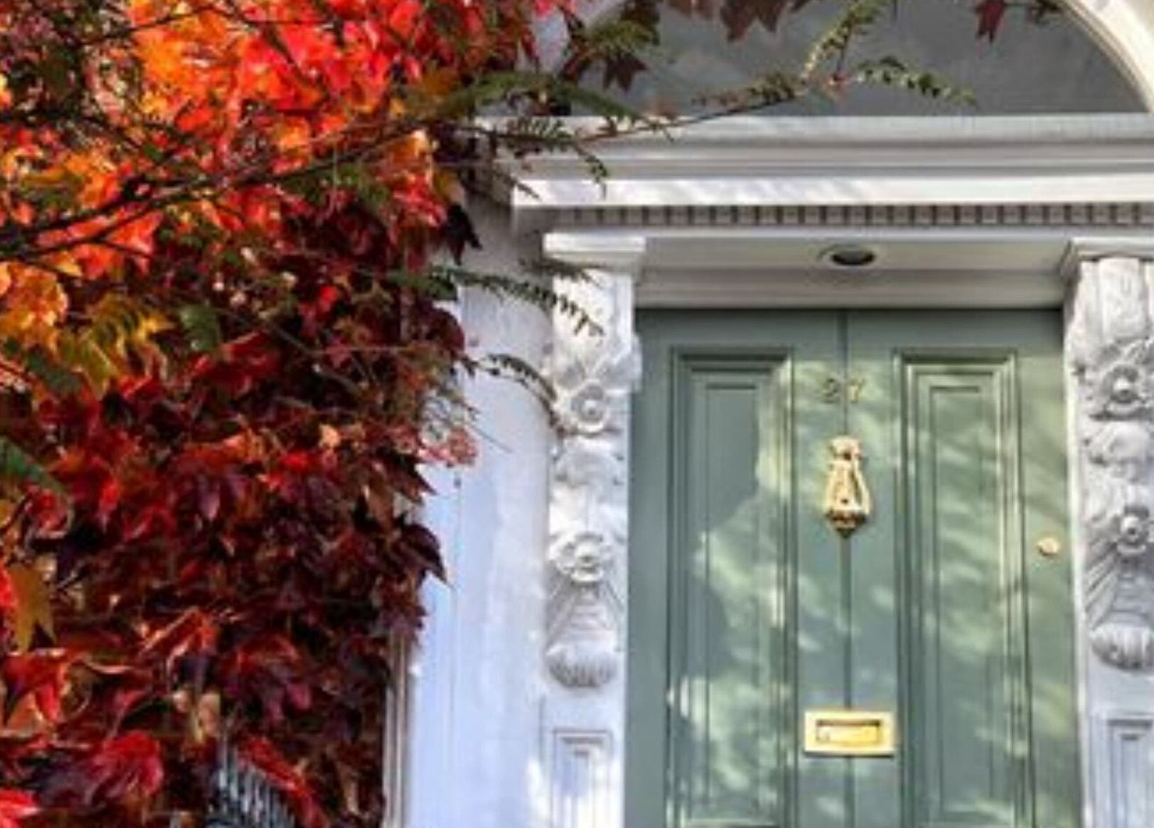 Charming entrance framed by vibrant leaves at Pretty Nails, Sidcup, England, GB.