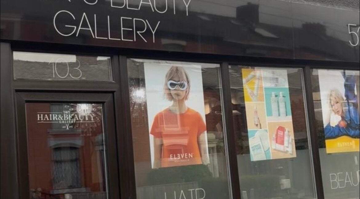 Front view of Hair and Beauty Gallery in Blackburn, England, showcasing stylish window displays.