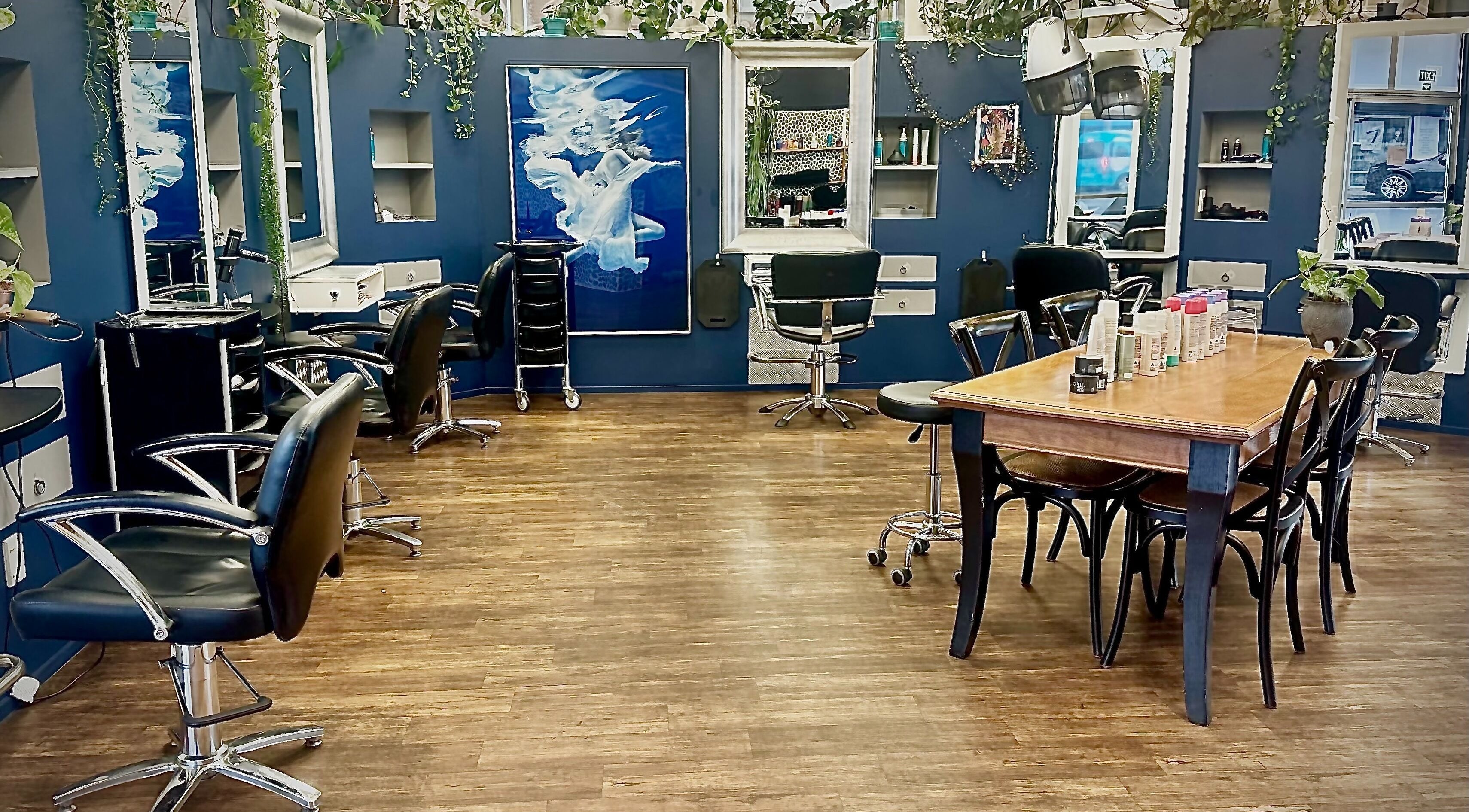 Modern salon interior at Hair Style in Tauranga, Bay of Plenty, NZ, featuring stylish chairs and elegant decor.