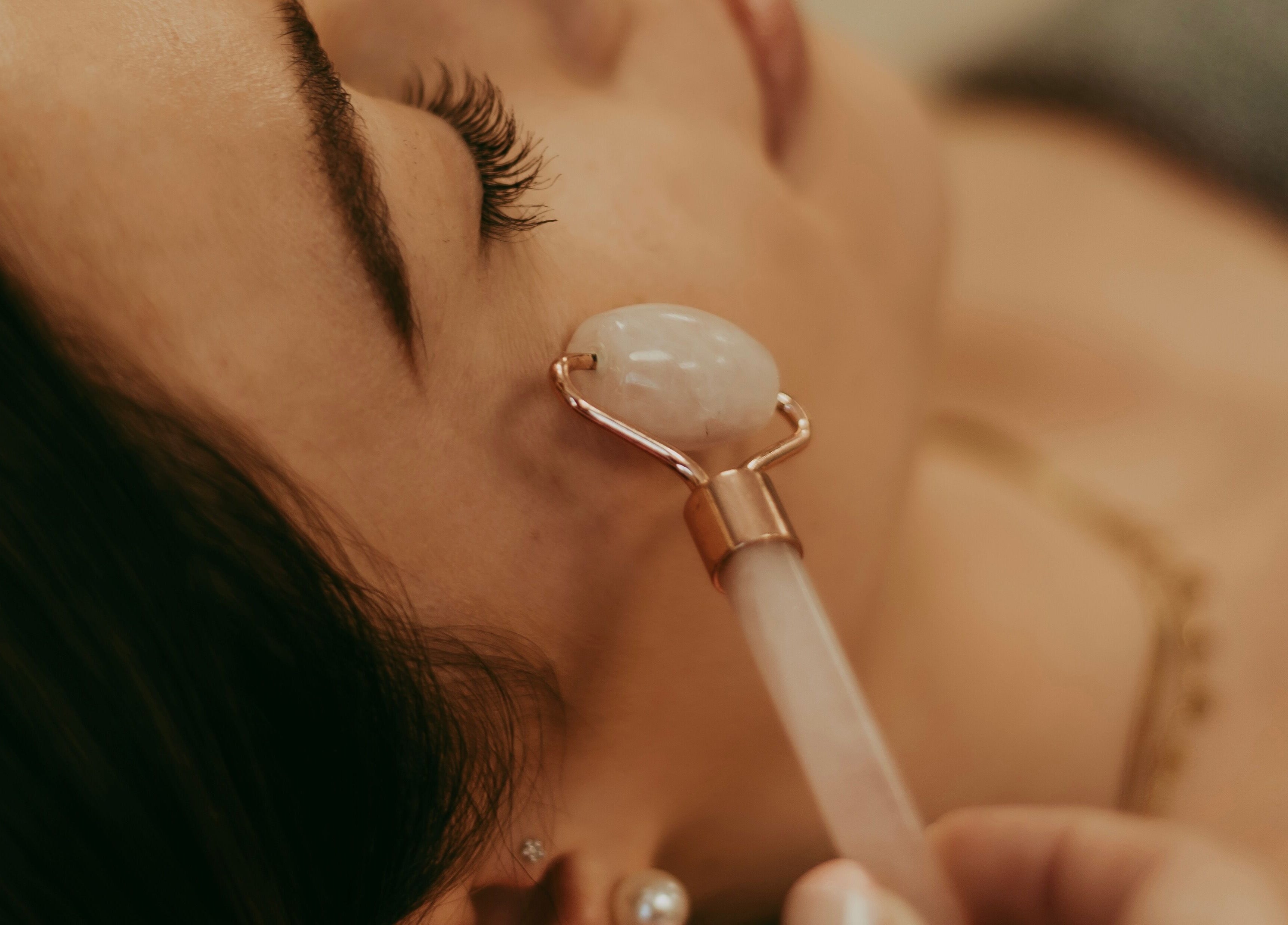 Facial massage at Haven Spa Namibia in Windhoek, Khomas Region, NA, using a jade roller for relaxation.