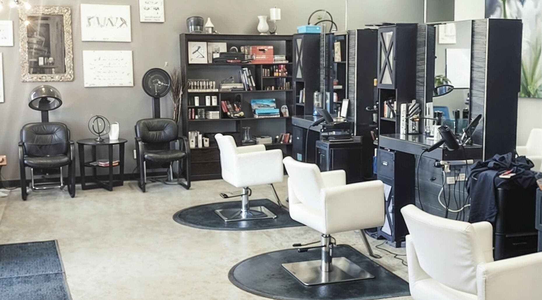 Modern salon interior at Crimson Hair Design in Regina, Saskatchewan, CA. Features sleek styling chairs and decor.