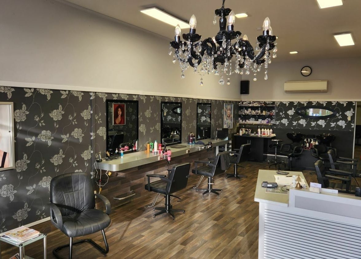 Chic interior of Chris and Co Hair Design, Pukekohe, Auckland, NZ with modern styling stations and chandelier.