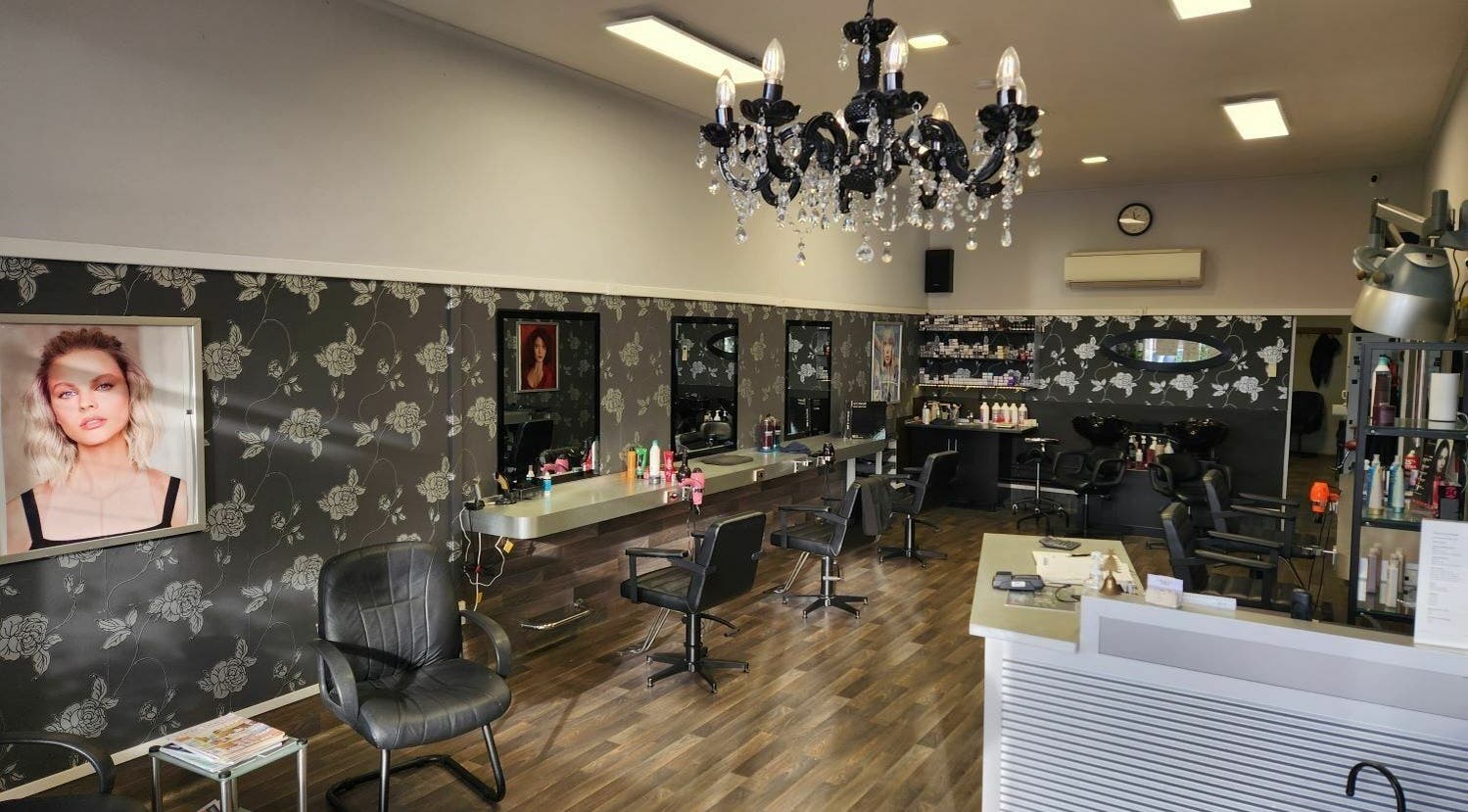 Chic interior of Chris and Co Hair Design, Pukekohe, Auckland, NZ with modern styling stations and chandelier.