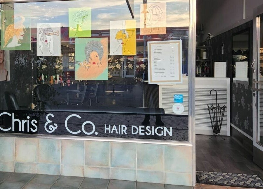 Front view of Chris and Co Hair Design in Pukekohe, Auckland, NZ, showcasing decorative window art.