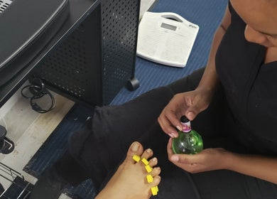 Foot treatment at The Goddess Loft, Nassau, New Providence, BS, showing nail polish application.