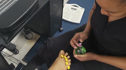 Foot treatment at The Goddess Loft, Nassau, New Providence, BS, showing nail polish application.