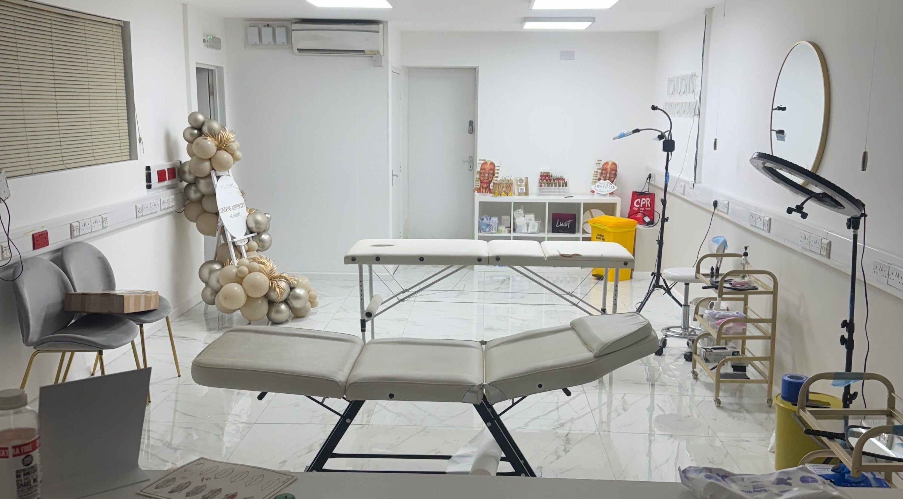 Modern treatment room at Levi Kimberley Aesthetics, West Drayton, England, GB, featuring massage tables and equipment.