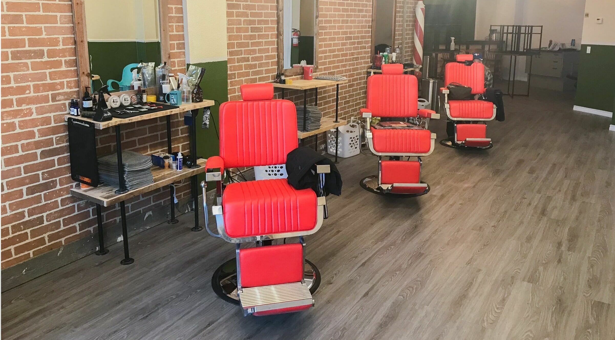 Red barber chairs at Fleet Street Barber Company in Quinte West, Ontario, CA showcasing a stylish interior.