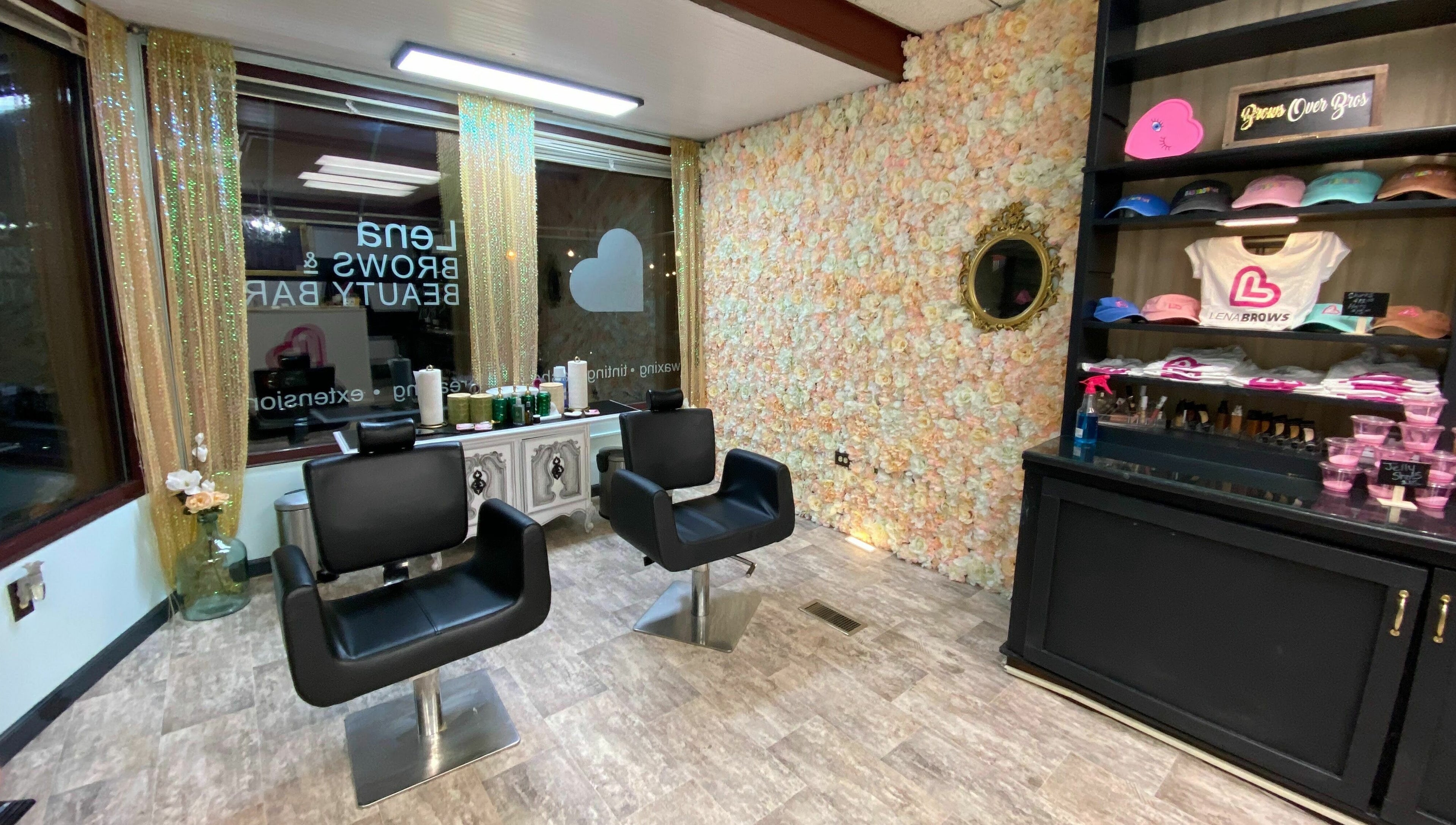 Modern salon chairs in Lena Brows and Beauty Bar, Sandusky, Ohio, US, with floral wall and product display.