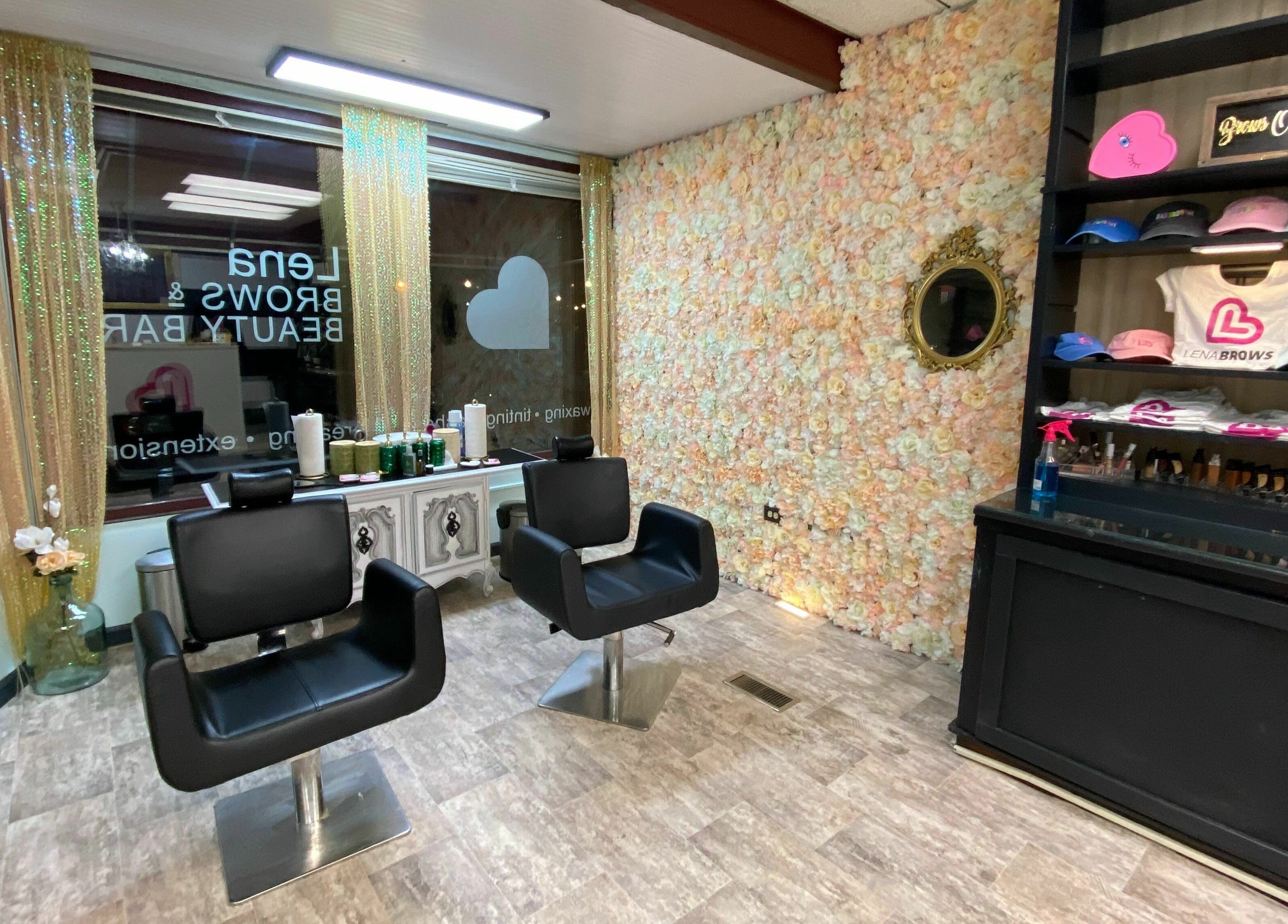 Modern salon chairs in Lena Brows and Beauty Bar, Sandusky, Ohio, US, with floral wall and product display.