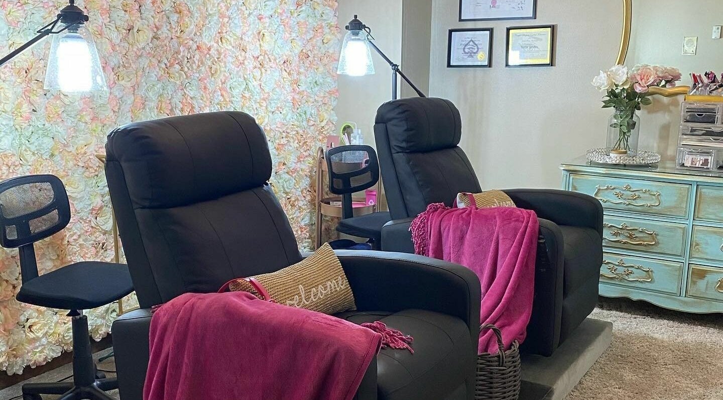 Relaxing seating area at Lena Brows and Beauty Bar in Sandusky, Ohio, US, featuring plush chairs and elegant decor.