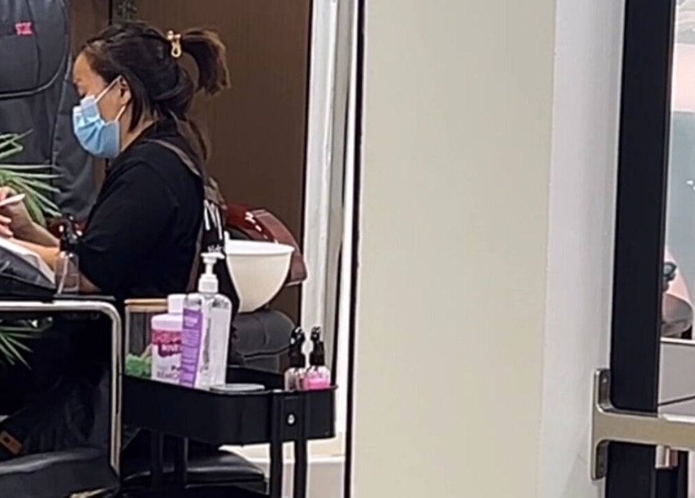 Professional manicurist at Naya Saloon in Sanabis, Muḥāfaẓat Al-ʿāṣimah, BH providing a relaxing nail treatment.